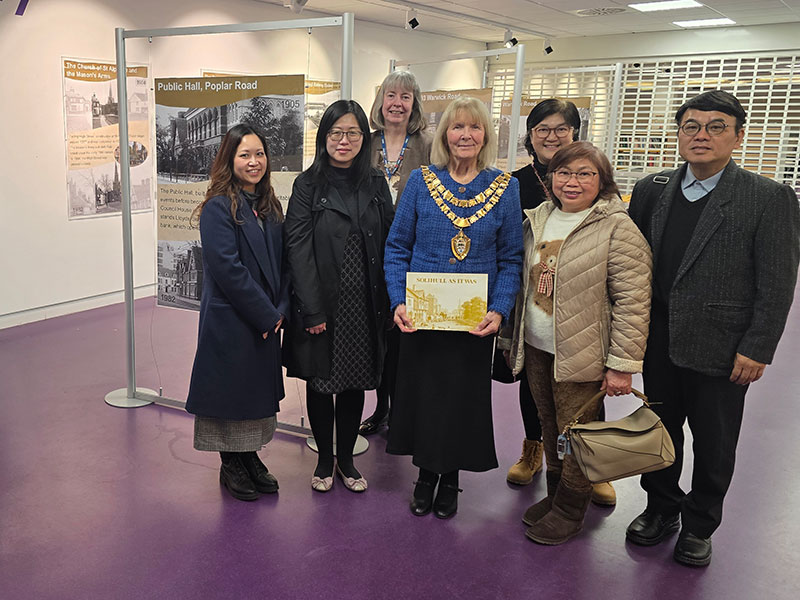 A group of people standing in an exhibition gallery